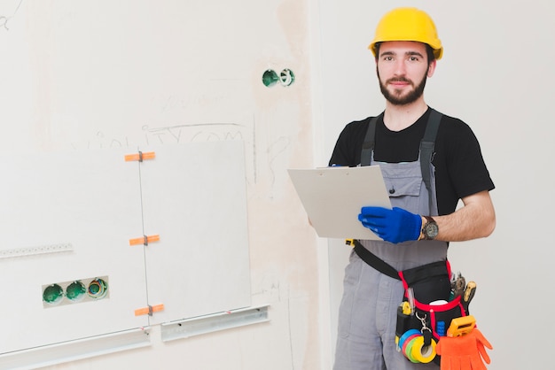 Electrician standing with paper folder