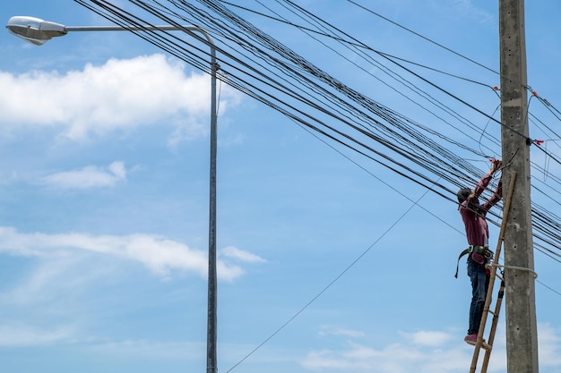 Electrician worker repairing power cable