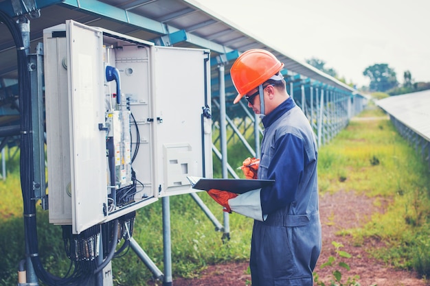 electrician working on checking and inspect equipment with checklist at outdoor industry 