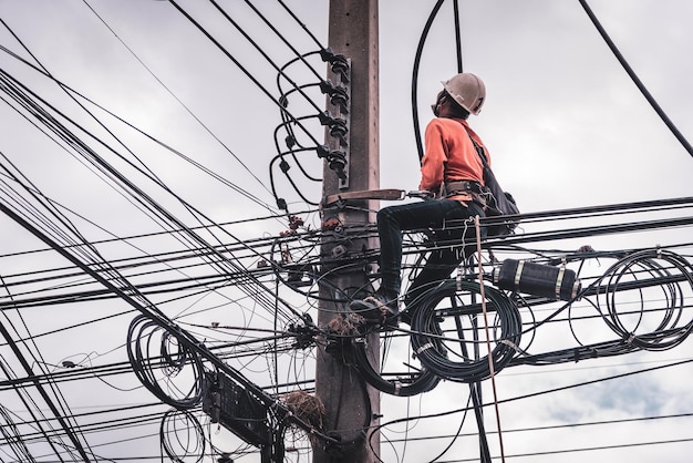 Electricians are climbing on electric poles to install and repair power lines