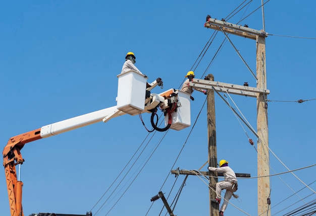 Electricians install equipment in the high-voltage system.