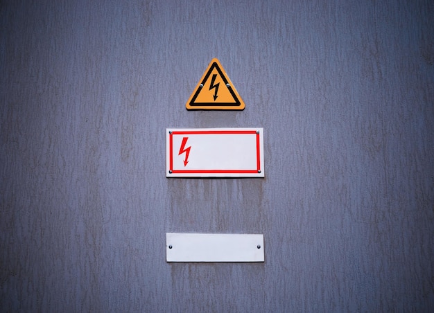 Electricity danger sign on vintage wall background