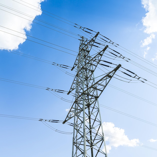 Electricity pylon on blue cloudy sky industry high voltage