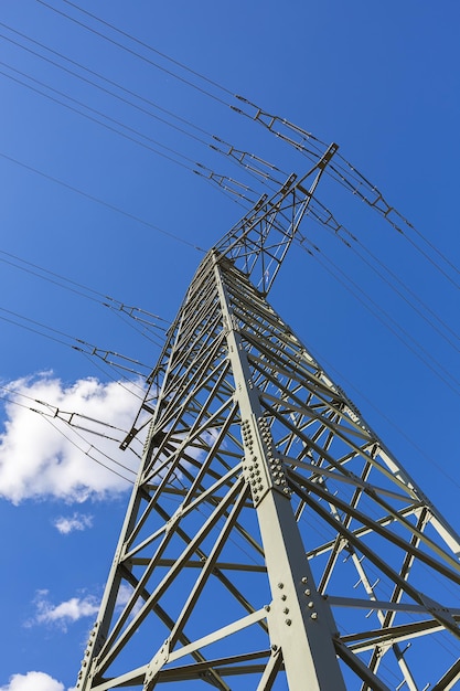 Electricity pylon on blue cloudy sky industry high voltage