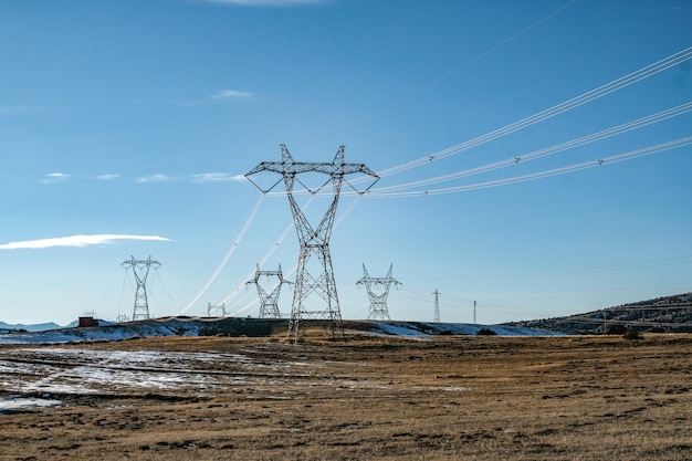 Electricity pylon on field against sky