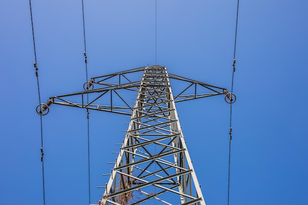 Electricity transmission power lines at sunset. High voltage tower