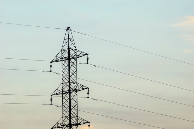 Electrification tower with cloudy sky.