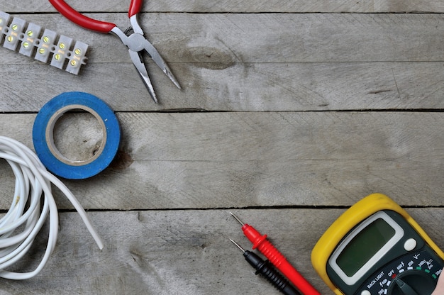 Electro tool and tester on a wooden background. copy space