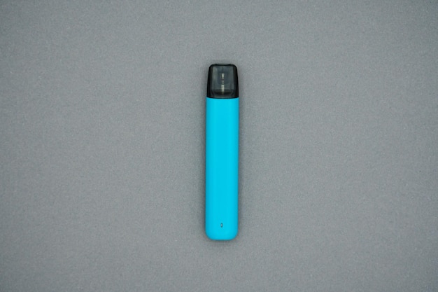 Electronic cigarette on a gray background. The concept of modern smoking vaping and nicotine