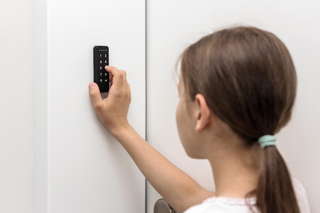 Electronic Code Lock near entrence door. Girl entering Security keypad entry Door Lock.