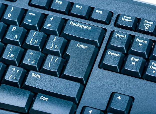 Electronic collection closeup black computer keyboard with russian letter focus on the Enter key