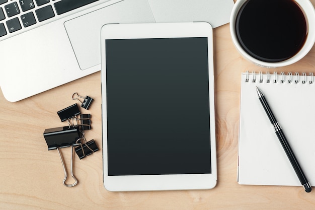 electronic gadgets and office supplies on wooden table