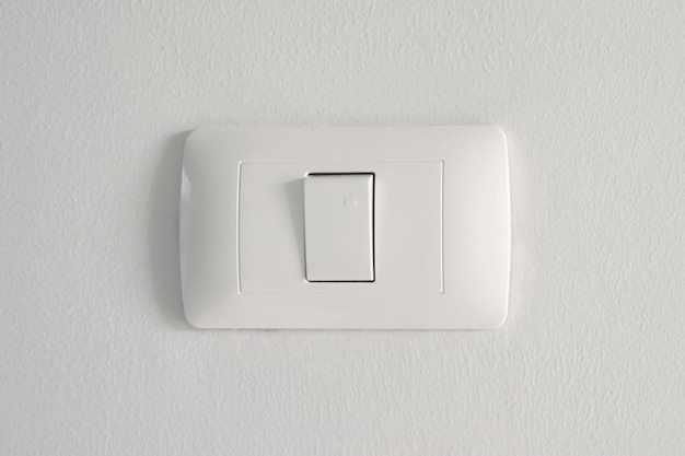 Electronic lighting switch with white wall background home electrical power