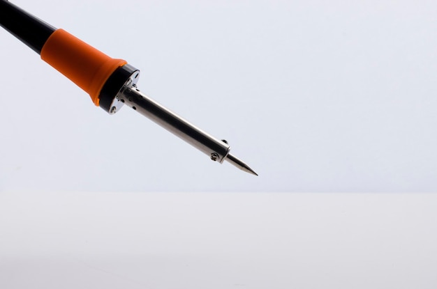 Electronic soldering iron on white surface. iron used in small solders of electronic components.