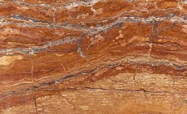 Photo elegance brown golden orange marble stone surface for interior or exterior