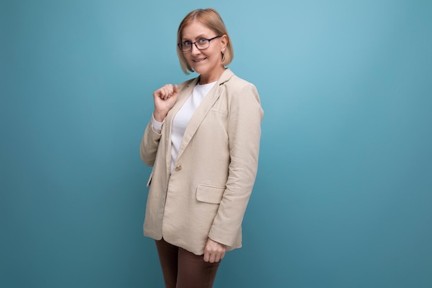 Elegant adult woman with a bob hairstyle in a stylish jacket on a plain background with copy space