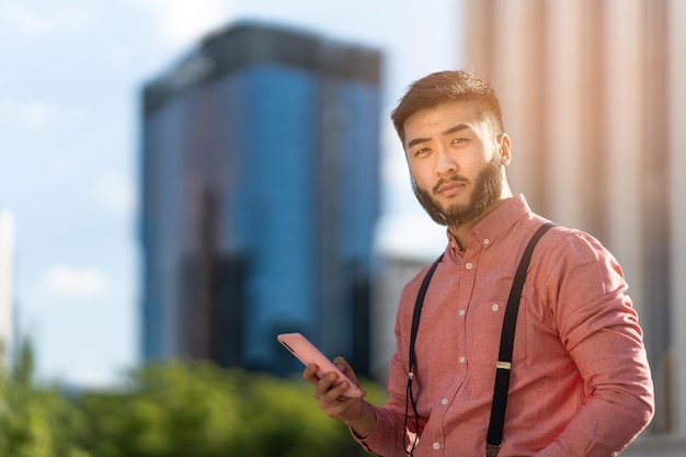 Elegant asian businessman using a mobile outdoors