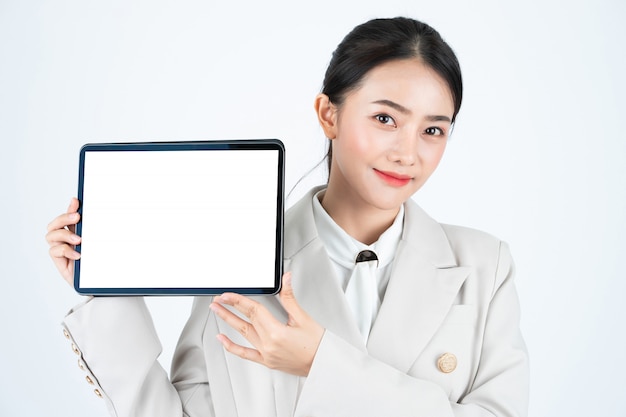 Elegant asian businesswoman show digital tablet with white blank screen