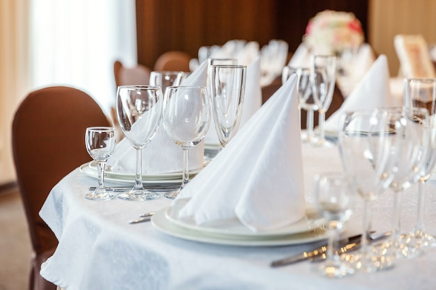 elegant banquet decoration and items for food arranged by catering service on white tablecloth table