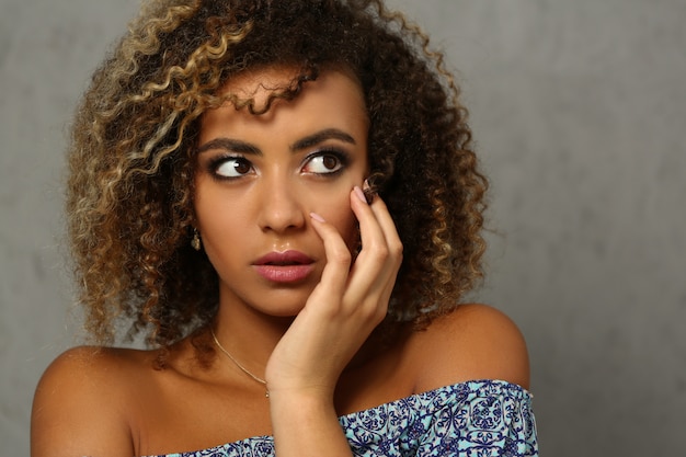 Elegant beautiful African American lady posing in dress