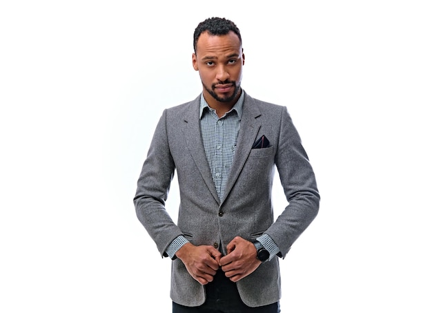 An elegant black American male dressed in a suit isolated on white background.