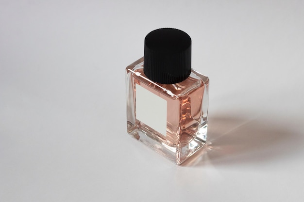 Elegant bottle of women's perfume close-up on an isolated background