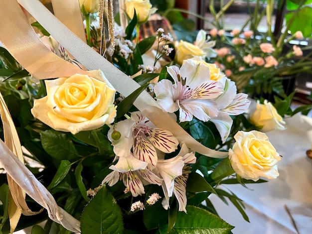 An elegant bouquet of colorful roses and green decorative leaves