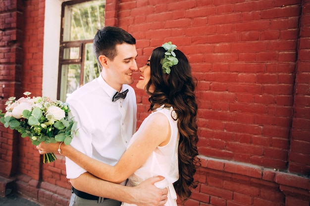 Elegant bride and groom posing together outdoors on a wedding day