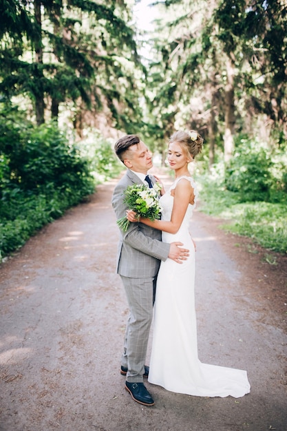 Elegant bride and groom posing together outdoors on a wedding day