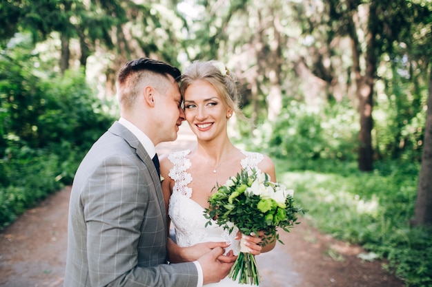 Elegant bride and groom posing together outdoors on a wedding day