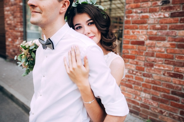 Elegant bride and groom posing together outdoors on a wedding day