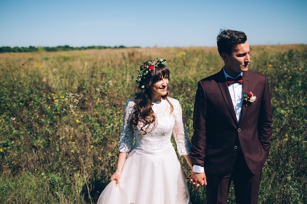 Elegant bride and groom posing together outdoors on a wedding day