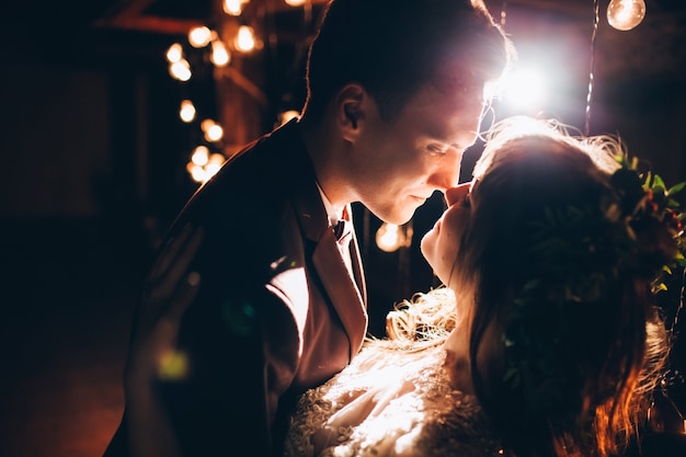 Elegant bride and groom posing together outdoors on a wedding day