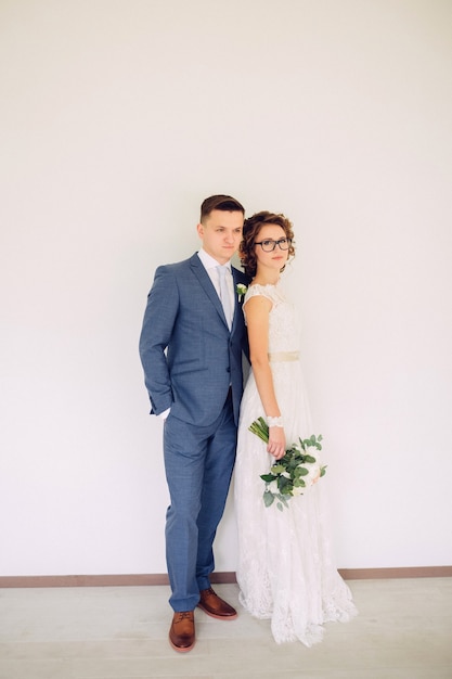 Elegant bride and groom posing together outdoors on a wedding day