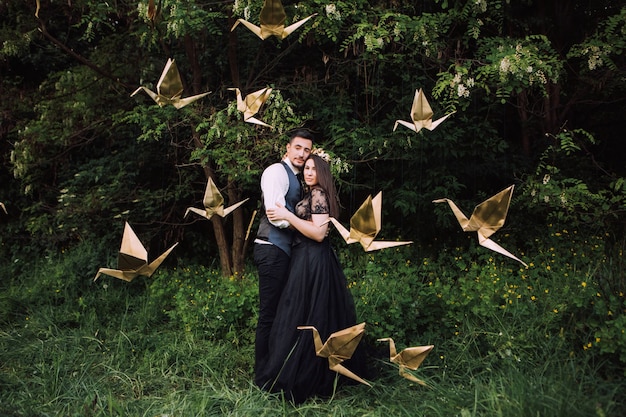 Elegant bride and groom posing together outdoors on a wedding day