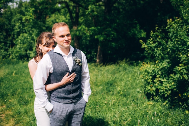 Elegant bride and groom posing together outdoors on a wedding day