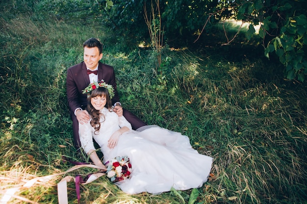 Elegant bride and groom posing together outdoors on a wedding day