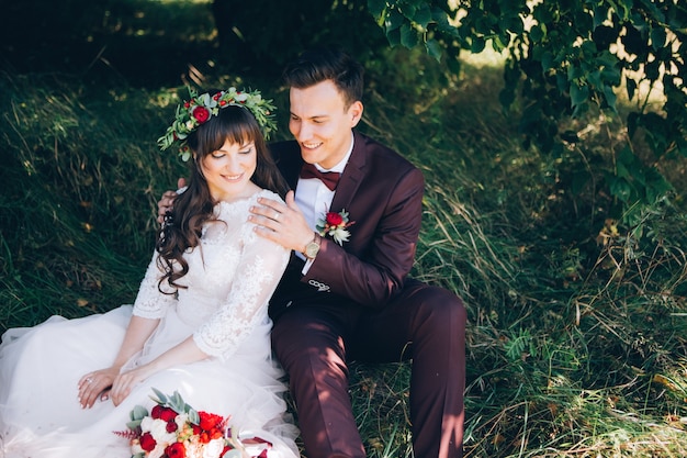 Elegant bride and groom posing together outdoors on a wedding day