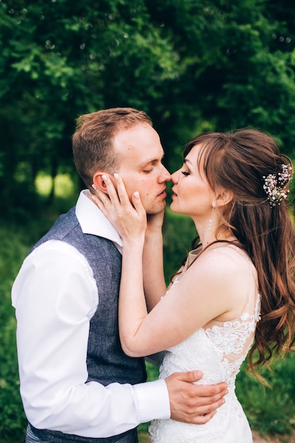 Elegant bride and groom posing together outdoors on a wedding day