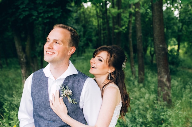 Elegant bride and groom posing together outdoors on a wedding day