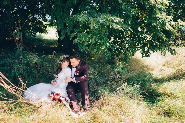 Elegant bride and groom posing together outdoors on a wedding day