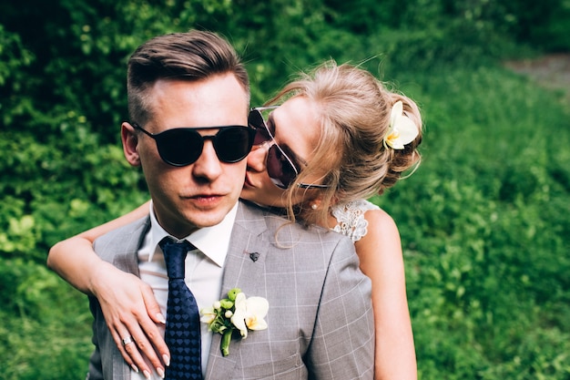 Elegant bride and groom posing together outdoors on a wedding day