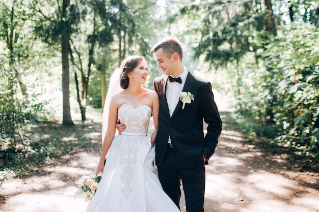 Elegant bride and groom posing together outdoors on a wedding day