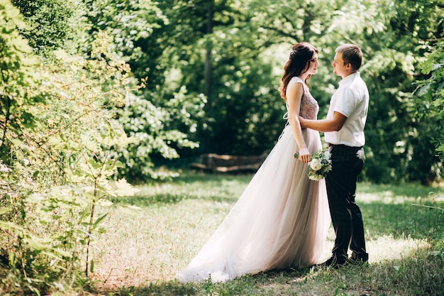 Elegant bride and groom posing together outdoors on a wedding day