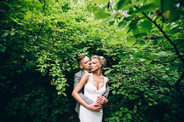 Elegant bride and groom posing together outdoors on a wedding day