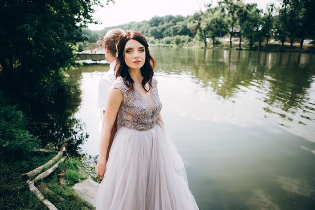 Elegant bride and groom posing together outdoors on a wedding day