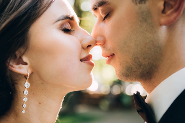 Elegant bride and groom posing together outdoors on a wedding day