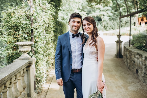 Elegant bride and groom posing together outdoors on a wedding day