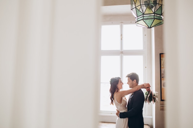 Elegant bride and groom posing together outdoors