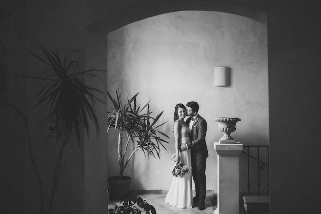 Elegant bride and groom posing together outdoors